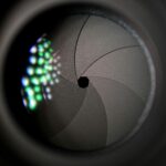 Detailed image of a camera lens aperture showing mechanical blades.